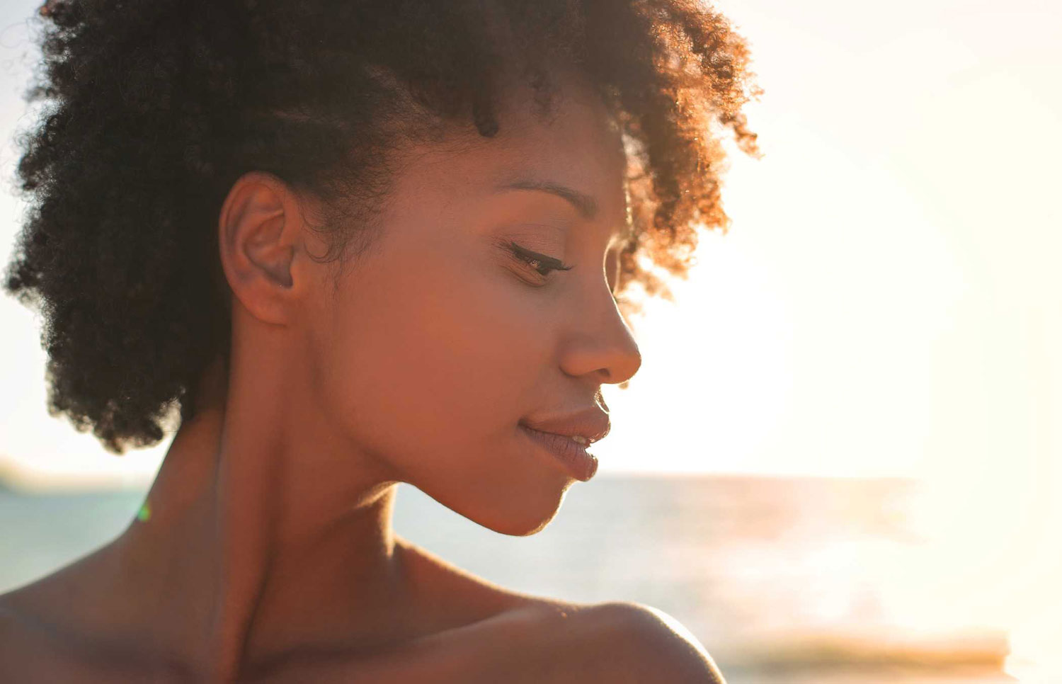 a woman smiling during sunset
